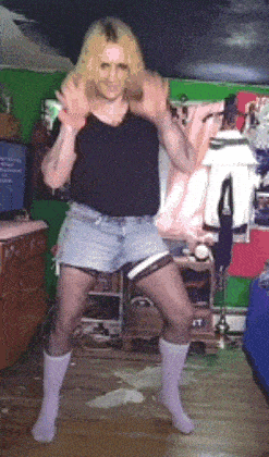 a man in shorts and socks is dancing in a room