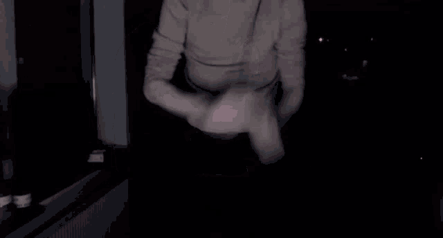 a man wearing headphones is running in a dark room .