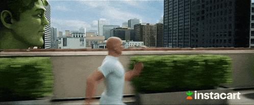 a man running in front of a green hulk with instacart written on the bottom right