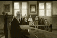 a judge is giving a speech in front of a group of people .