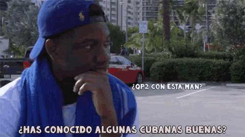 a man with a towel around his neck is asking has conocido algunas cubanas buena