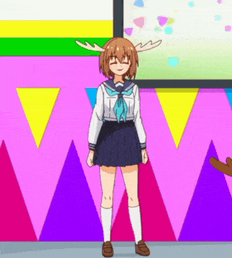 a girl with antlers on her head stands in front of a pink wall