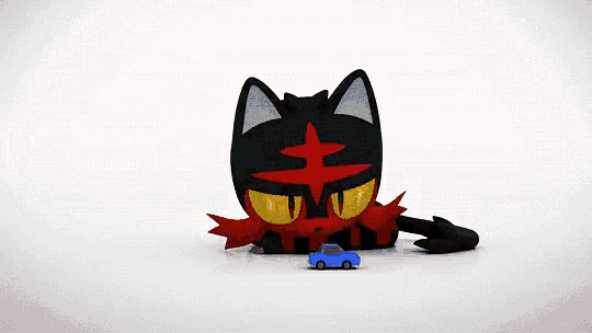 a cartoon cat is laying down next to a small blue toy car