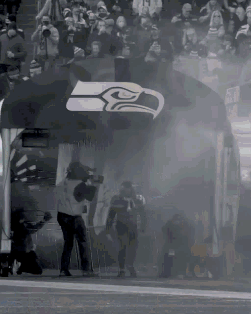 a seattle seahawks logo is visible on a black and white photo