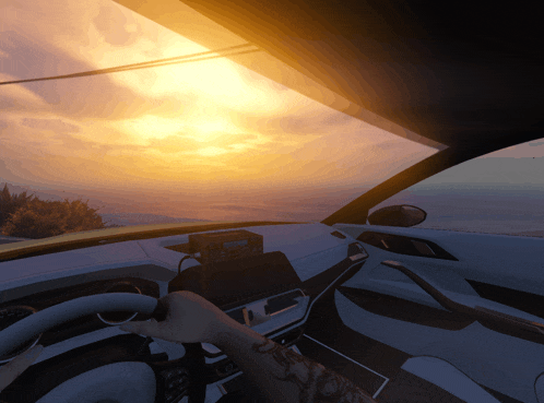 a person driving a car with the sun setting in the background