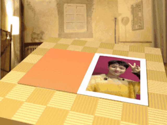 a picture of a woman giving the peace sign is on a table