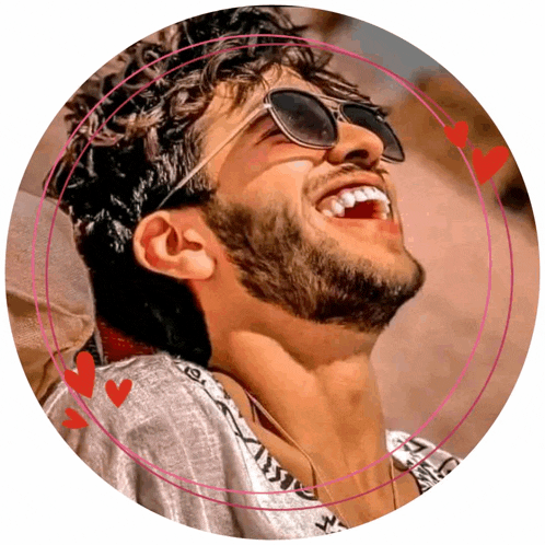 a man wearing sunglasses is laughing in a pink circle