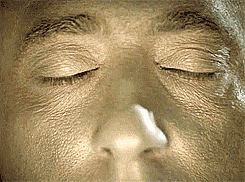 a close up of a person 's face with their eyes closed .