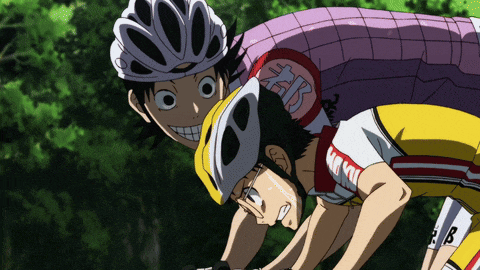 a man wearing a helmet with the letter b on it is standing next to another man