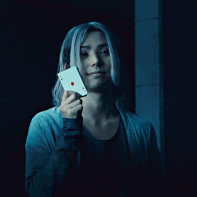 a man with long blonde hair wearing a blue jacket