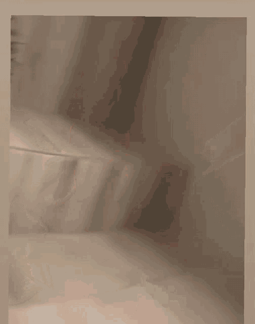 a blurred image of a person 's foot on a tile floor