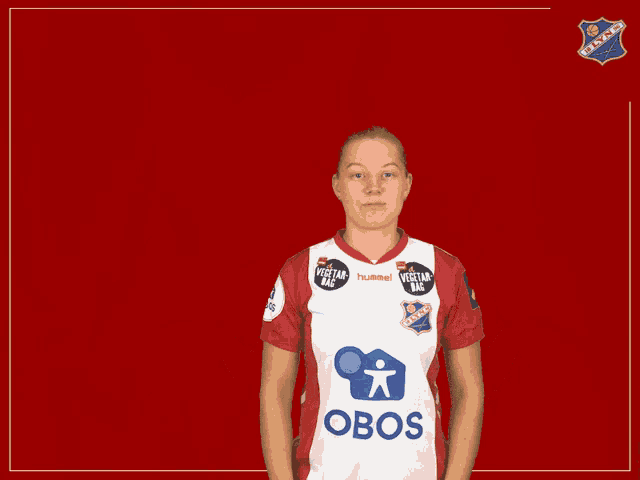 a woman wearing a red and white shirt that says obos on it