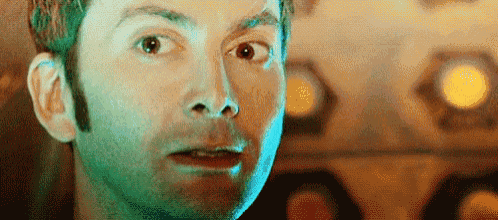 a close up of a man 's face with a surprised look on it .