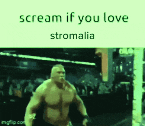 a man without a shirt is screaming while standing in front of a crowd .