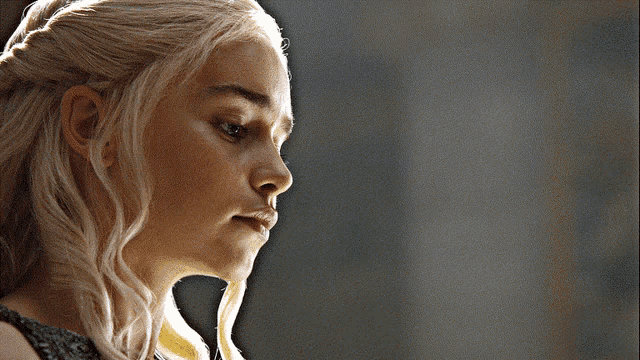 a woman with blonde hair looks down at something