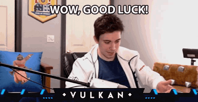 a man sitting in front of a microphone with the words wow good luck
