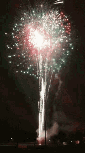 a fireworks display with a red white and green color scheme