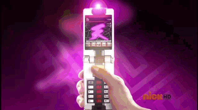 a person is holding a cell phone in their hand with a pink light coming out of the screen .