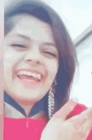 a close up of a woman 's face with a smile on her face .