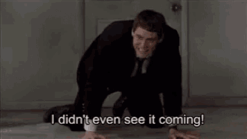 a man in a suit and tie is kneeling on the floor and saying `` i didn 't even see it coming ''