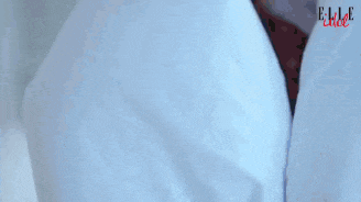 a man is laying under a white blanket with elle written on the bottom