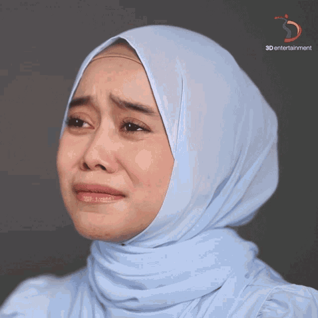 a woman wearing a hijab is crying with a 3d entertainment logo in the corner