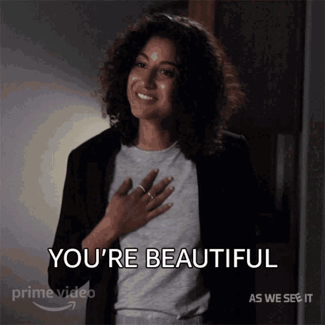 a woman with her hand on her chest and the words you 're beautiful above her