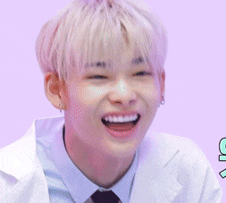 a young man wearing a white coat and tie is smiling