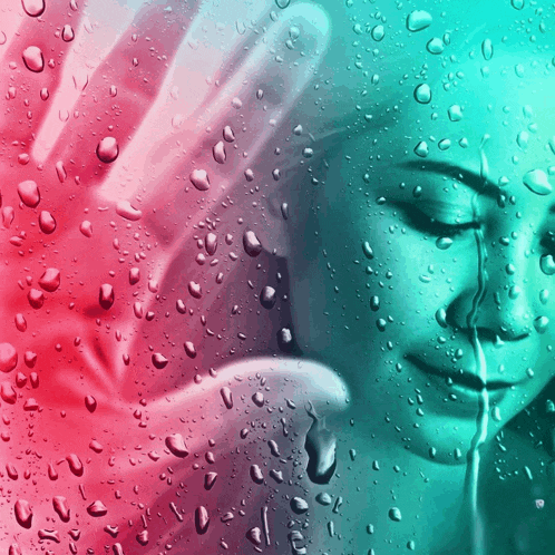 a woman 's face is behind a window covered in water drops