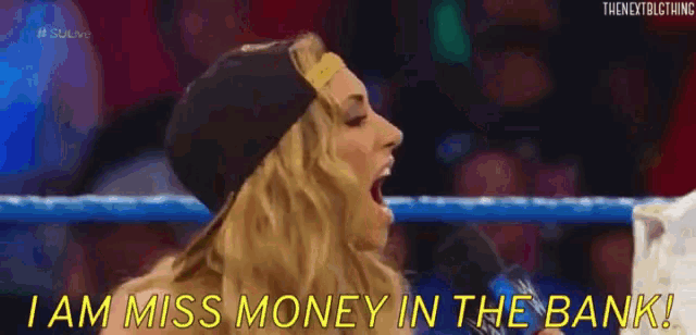 a woman is standing in a wrestling ring and saying i am miss money in the bank .
