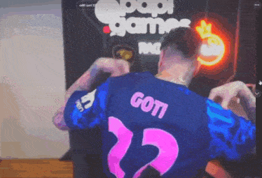 a man is wearing a blue and pink jersey with the number 22 on the back