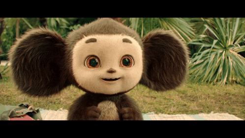 a stuffed animal with big eyes is smiling and looking at the camera