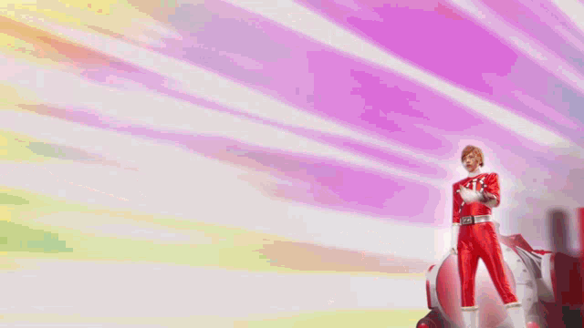 a woman in a red superhero suit is standing on a red train