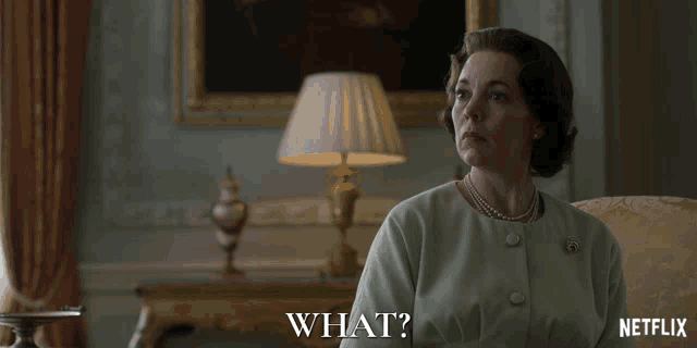 a woman is sitting in front of a lamp and says what on the screen