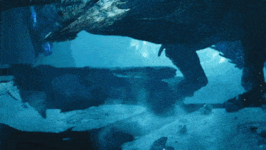 a large monster is swimming in the water with smoke coming out of its mouth