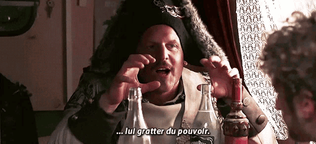 a man holding a bottle of jack daniel 's whiskey says " lui gratter du pouvoir "