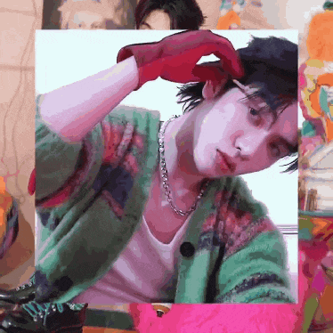 a pixelated image of a man in a green cardigan