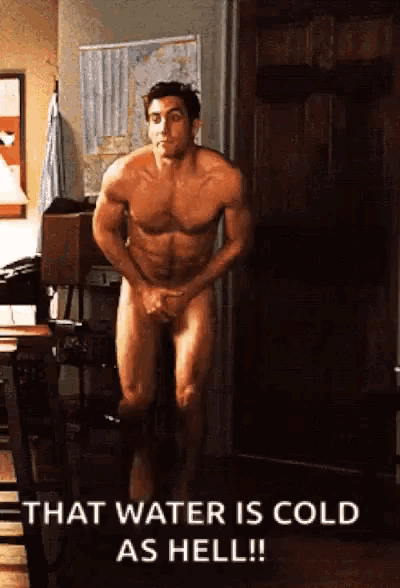 a naked man is standing in front of a door and says that water is cold as hell
