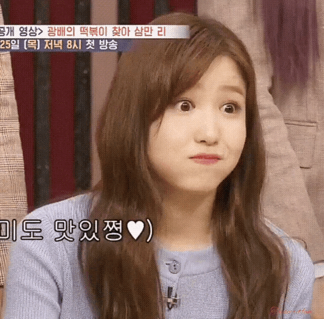 a girl with long hair is making a funny face in front of a sign that says ' 25 ' on it