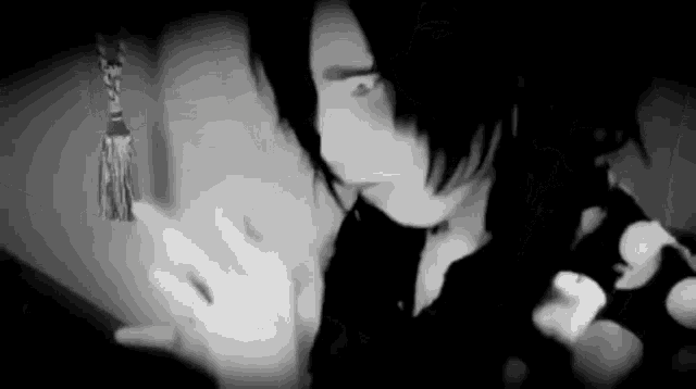 a black and white photo of a person looking at something .
