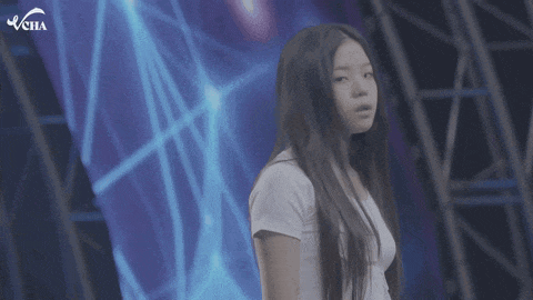 a girl with long hair is standing in front of a blue background with the word vcha on it