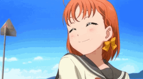 a girl with red hair and a yellow bow on her ear is smiling .