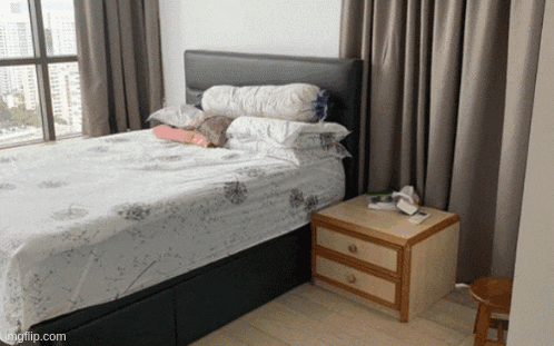 a bedroom with a bed and a nightstand with kingflip.com on the bottom