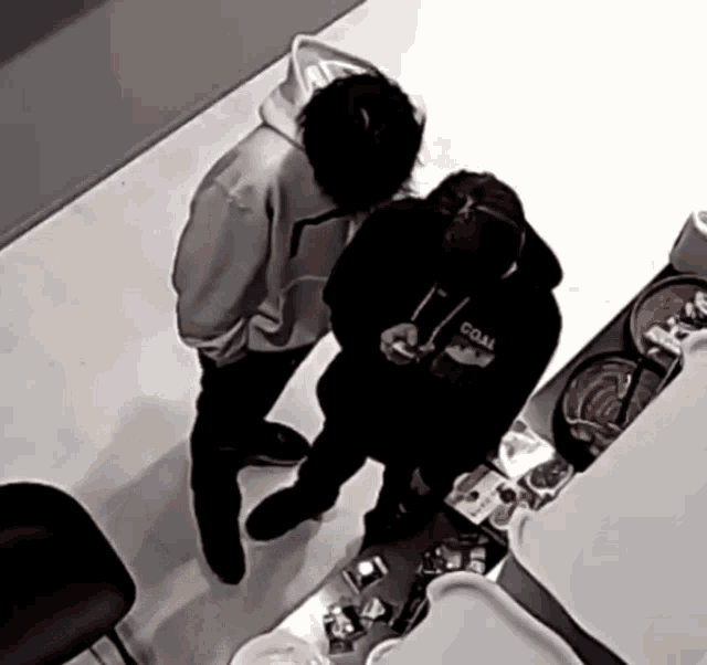 a man wearing a black hoodie that says coal