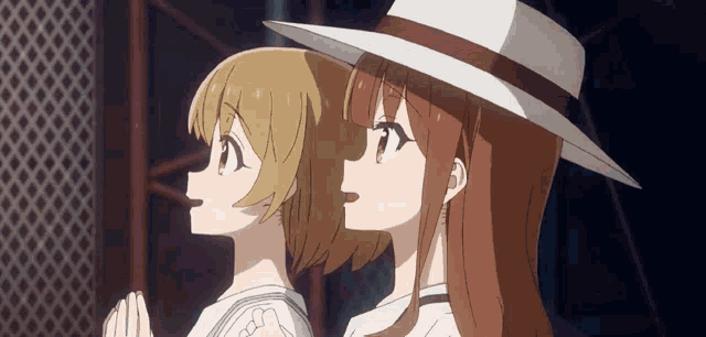 two anime girls wearing hats are praying together