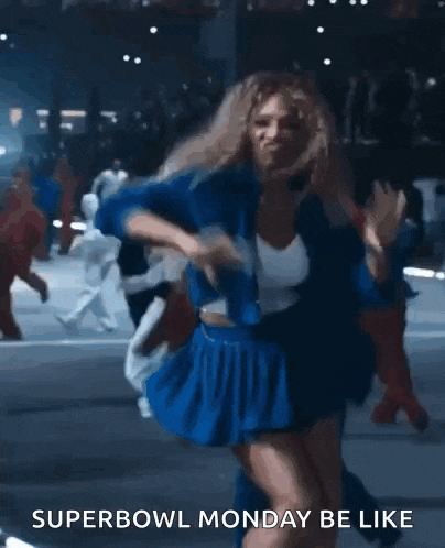 a woman in a blue skirt is dancing on a street with a caption that says superbowl monday be like