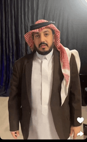 a man with a beard wearing a suit and a scarf