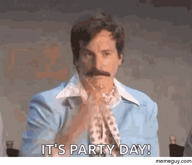 a man with a mustache is sitting at a table with his hands folded and says `` it 's party day ! ''