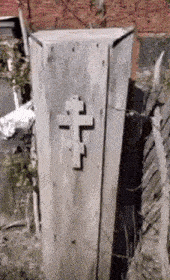 a coffin with a cross on it is sitting in the dirt