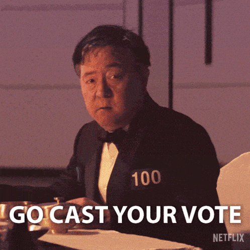 a man in a tuxedo with the number 100 on his chest says " go cast your vote "